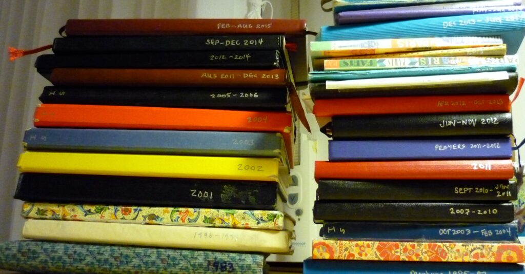 Stacks of journals with dates on bound edge