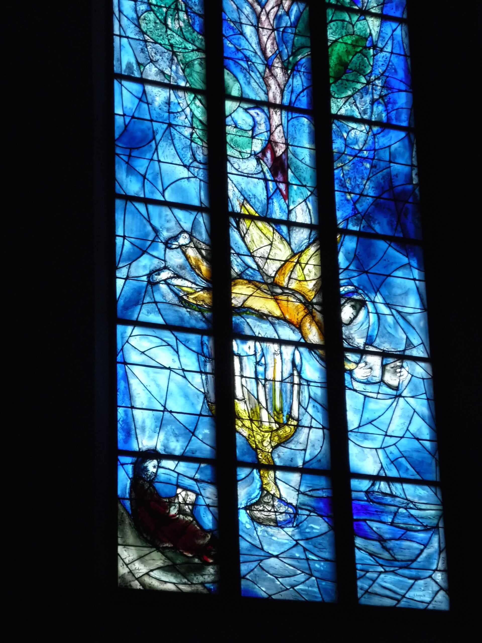 "Your Word is Lamp unto My Feet." Stained glass window in shades of blues with flying angel and candelabra by Marc Chagall/ Charles Marq. Pfarrkirche St. Stephan, Mainz, Germany, 2016.