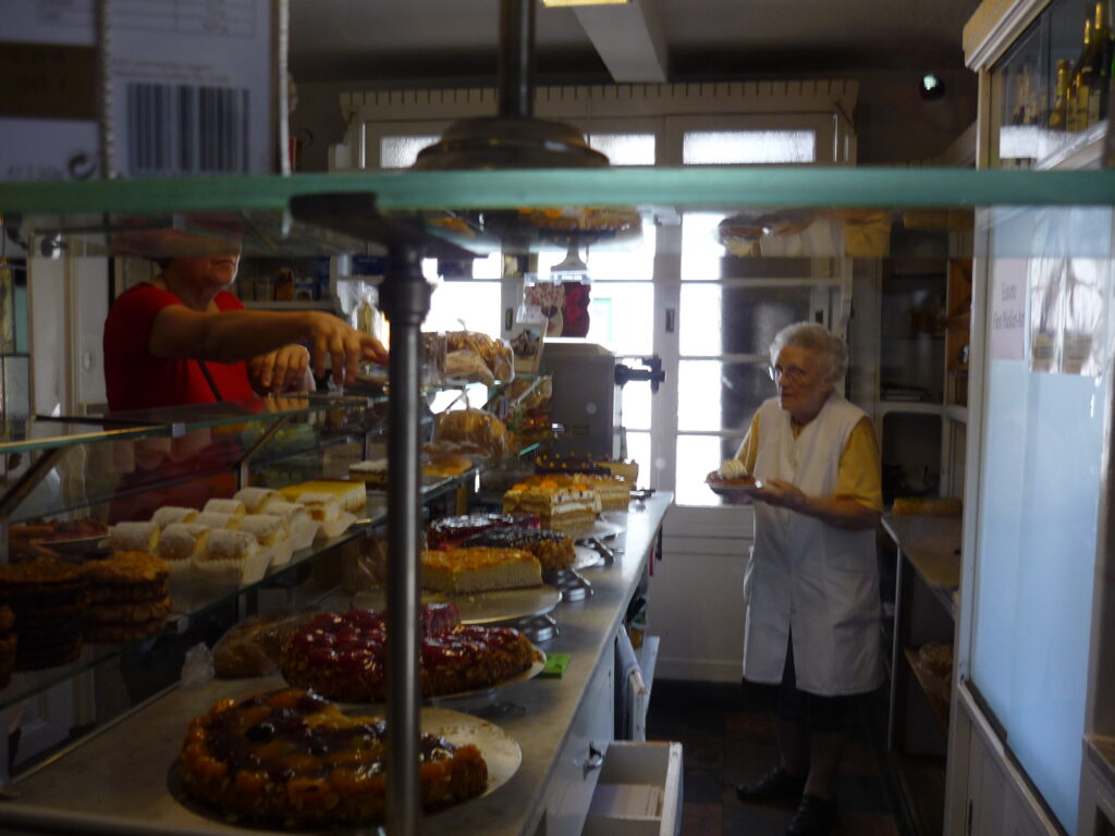 woman working in bakery with beautiful tortes