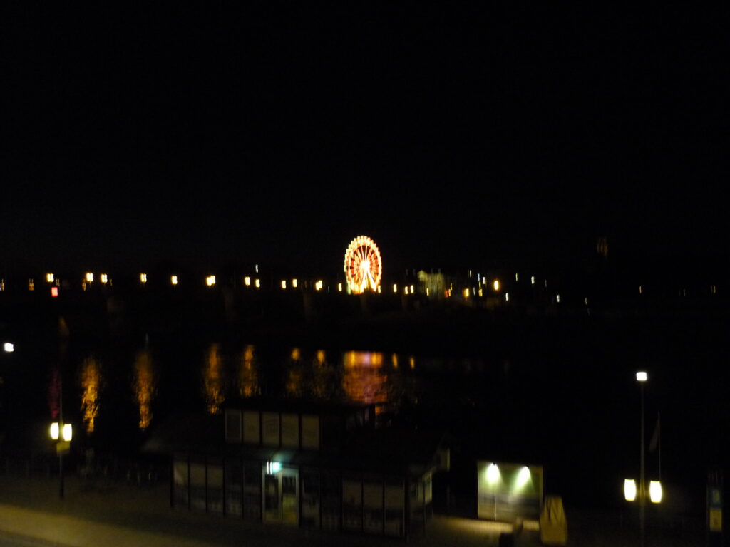 ferris wheel lit up against dark night