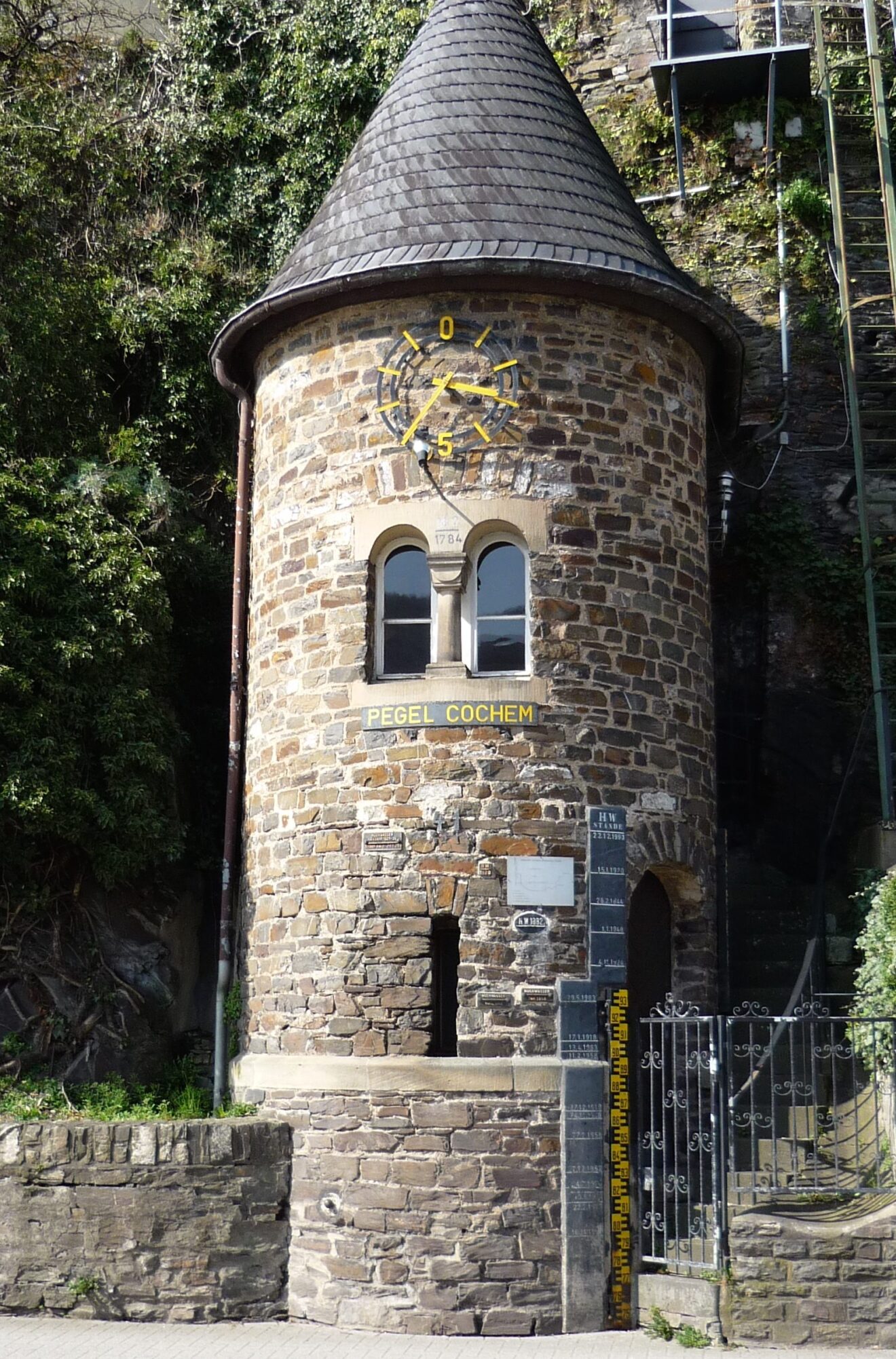 castle with towers and rooks, blooming pink cherry trees, tower with windows and door that make a funny, surprised face, Mosel river valley