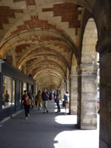 Brick and stone arcade with bookstores in Paris.