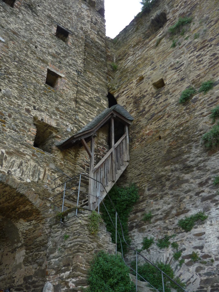 ancient castle wall with steep roofed stairs