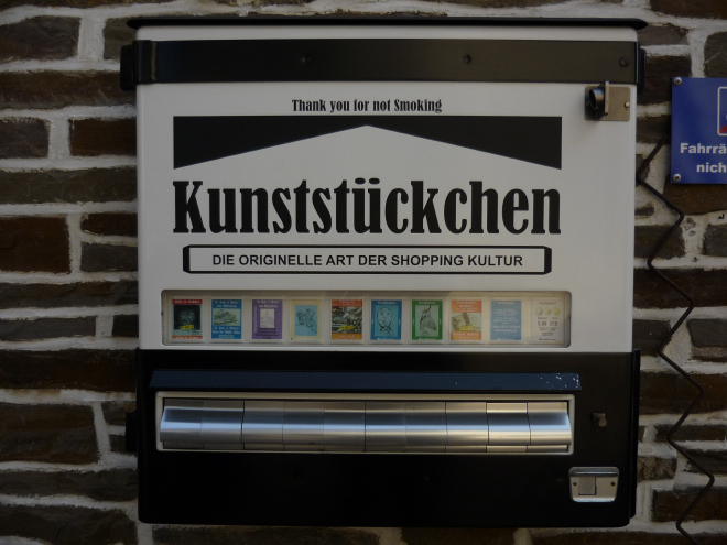 A vending machine for art. It looks like it was re-purposed from a cigarette vending machine.