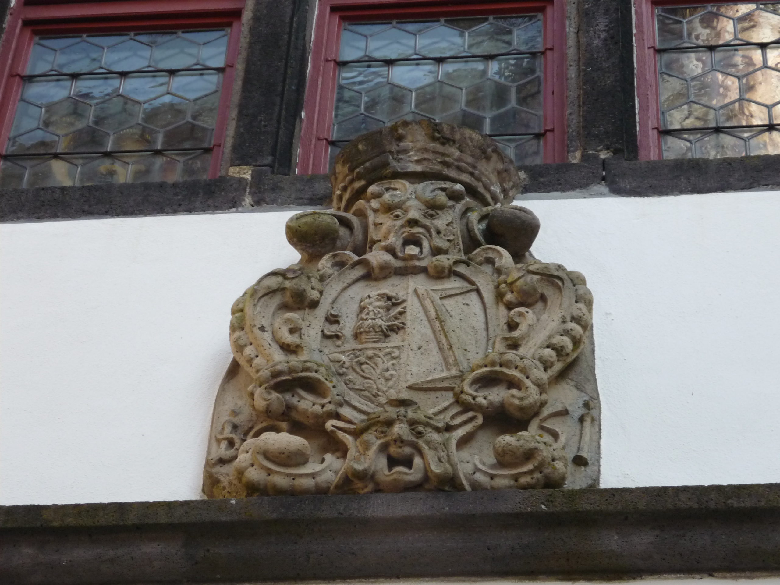 Horrified stone face on castle decoration