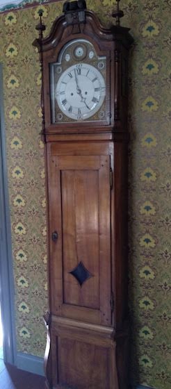 grandfather clock with antique wallpaper