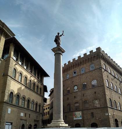 Justice statue on top of a pedestal Florence Italy