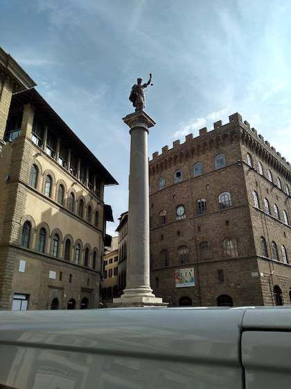 Justice statue on top of a pedestal Florence Italy