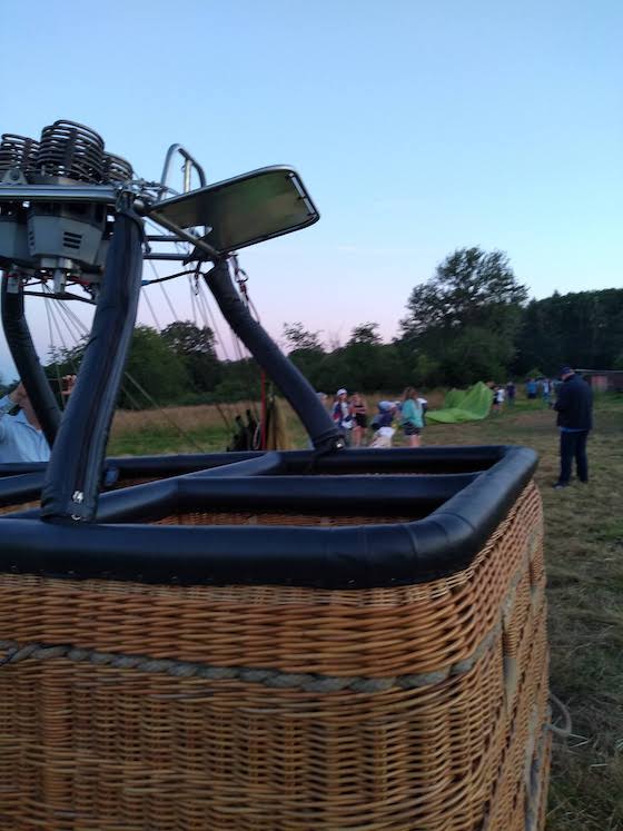 basket with deflated balloon folded on the ground