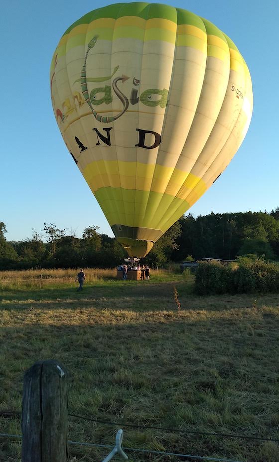 holding down the basket to keep the balloon from flying